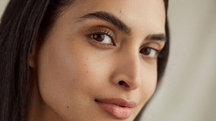 Close-up portrait of a person with a natural complexion and luminous-looking skin.
