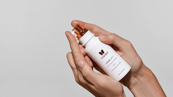 Close-up of Vivier Crème 47 Luxe Concentrate held in hands with cream dispensed from the pump.