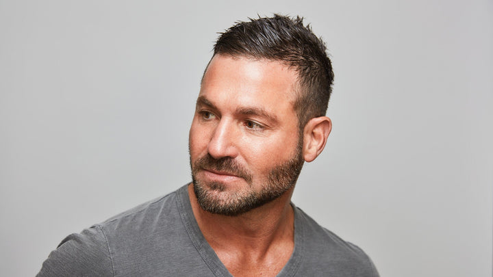 Confident man with clear, healthy skin looking to the side, showcasing the results of a simple and effective skincare routine.