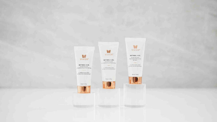 Collection of Vivier skincare serums in amber glass bottles with rose gold droppers displayed side by side.